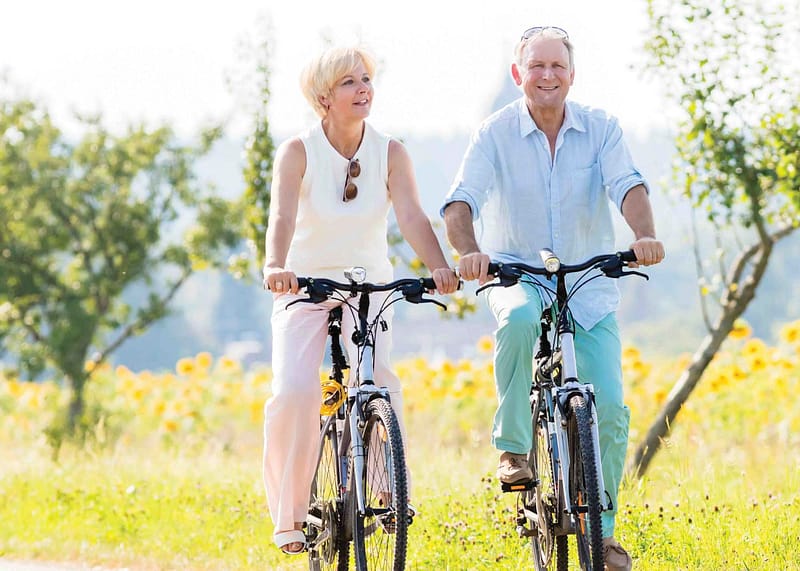 Older couple on bikes